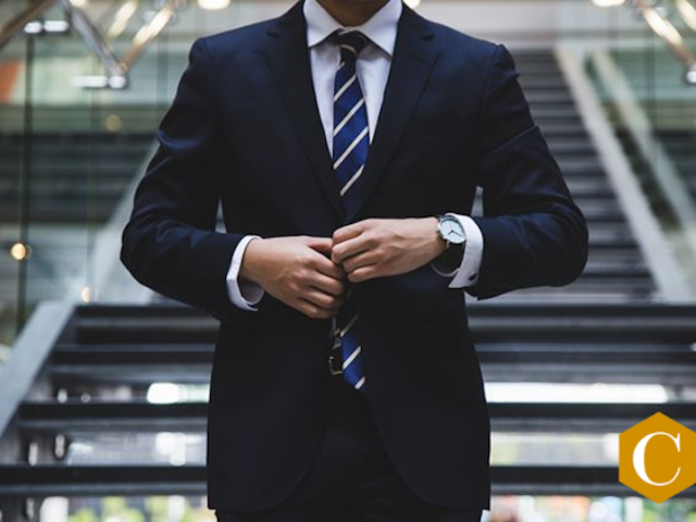 image of male buttoning suit