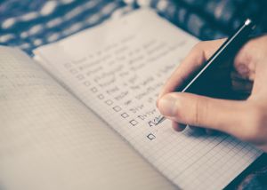 hand writing on a checklist in a notebook