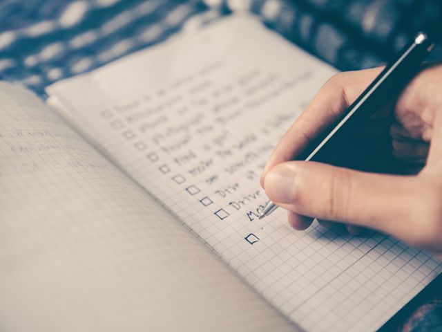 hand writing on a checklist in a notebook